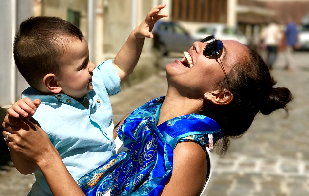 laughing mother holding her baby